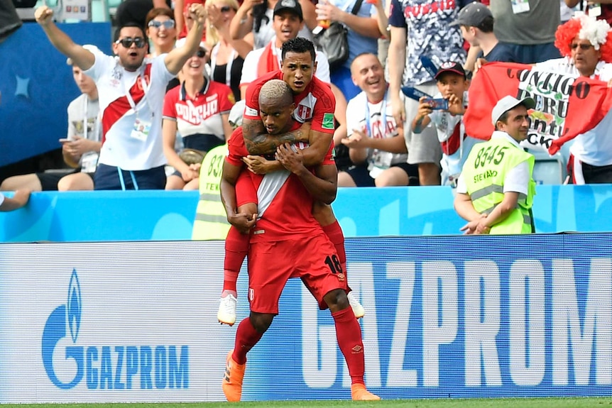 Andre Carillo is jumped on top of after scoring goal