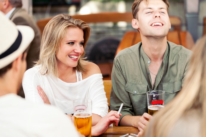 Young people in bar smoking and drinking