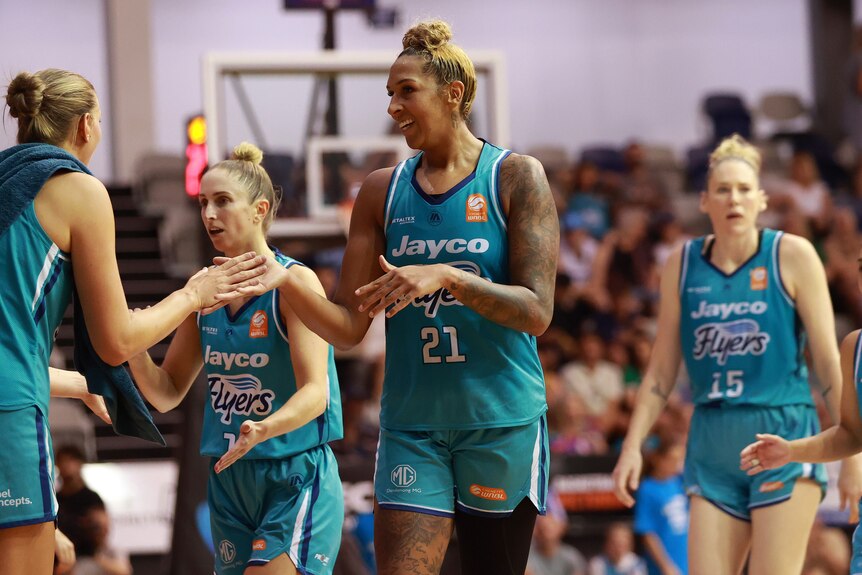Mercedes Russell of the Southside Flyers high fives a WNBL teammate