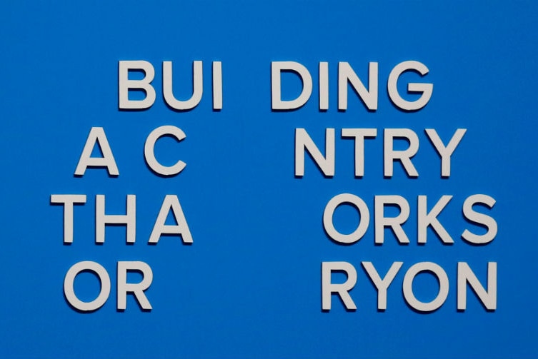 The slogan is seen after more letters fell off immediately after the address. It now reads: BUI DING A C NTRY THA ORKS OR RYON