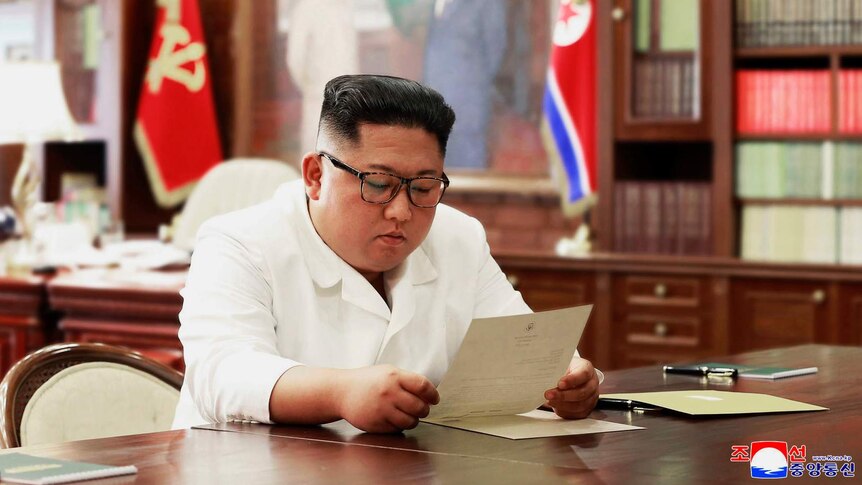 North Korean leader Kim Jong-un reads a letter from US President Donald Trump.