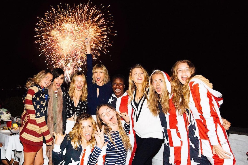 Taylor Swift, Cara Delevingne, Gigi Hadid, Blake Lively and Ruby Rose embrace in front of a bursting firework