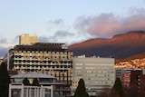 Two buildings of the Royal Hobart Hospital with kunanyi/Mount Wellington visible in the background