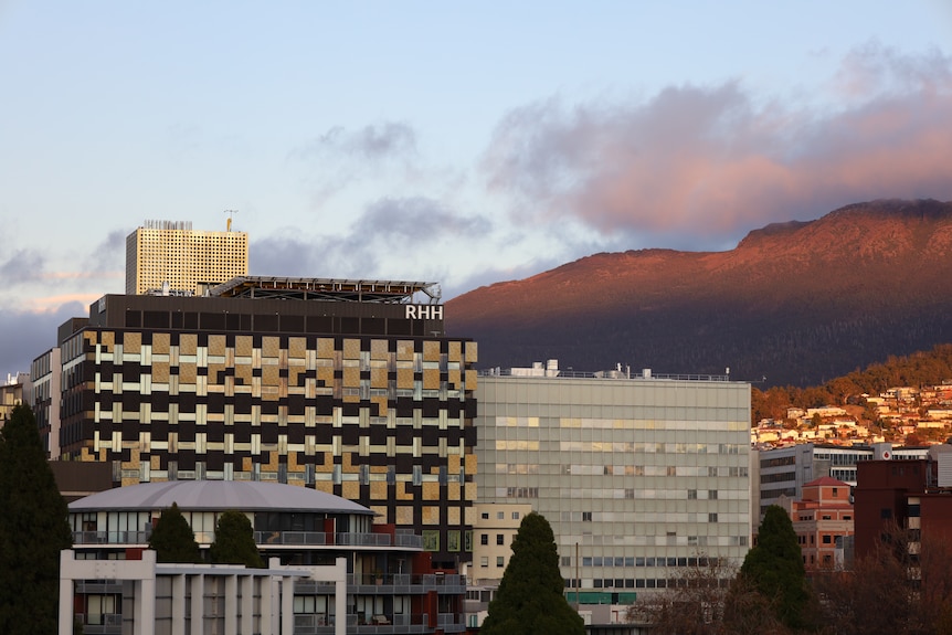 Two buildings of the Royal Hobart Hospital with kunanyi/Mount Wellington visible in the background