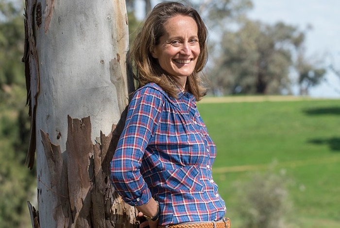 Farmer Clare Cannon leaning against a tree