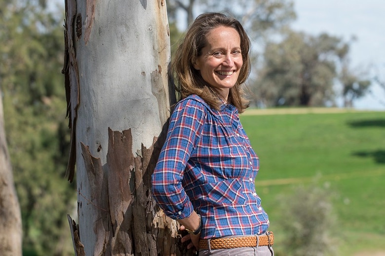 Farmer Clare Cannon leaning against a tree