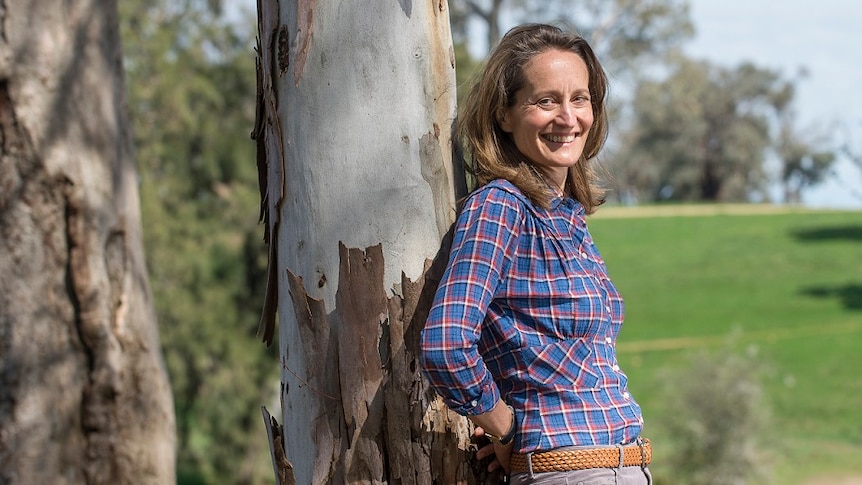 Farmer Clare Cannon leaning against a tree