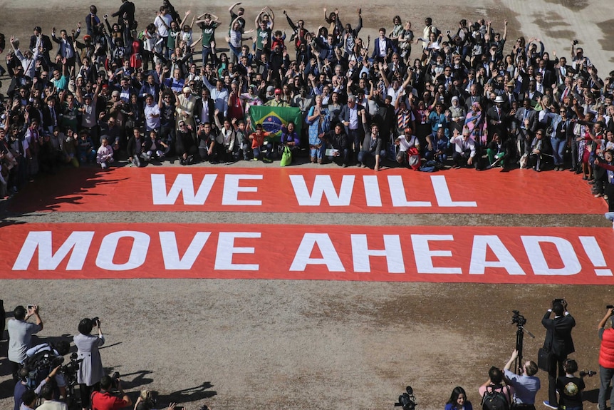 Participants stage a public show of support for climate talks in Marrakesh, Morocco.