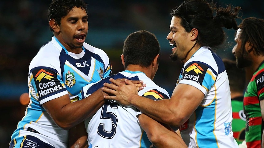 Titans celebrate a try against the Rabbitohs