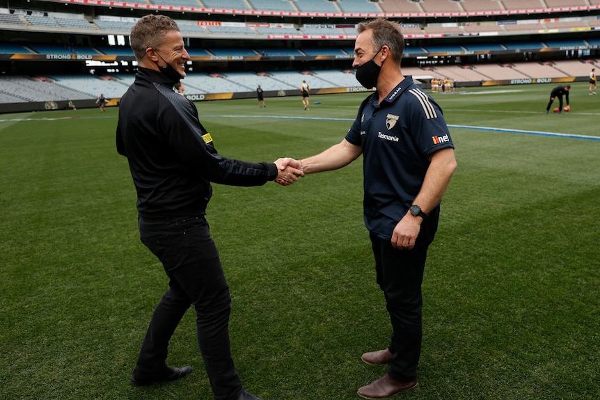 Richmond's Damien Hardwick shakes hands with Hawthorn's Alastair Clarkson ahead of Clarkson's final game as coach. 