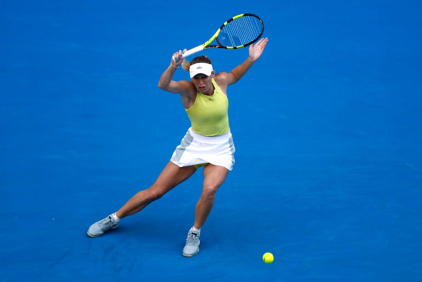 Caroline Wozniacki hits the ball in her match against Mihaela Buzarnescu at the Australian Open.