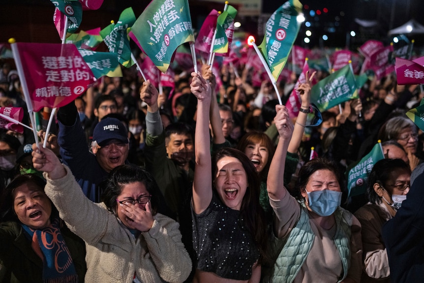 A group of people waving flags