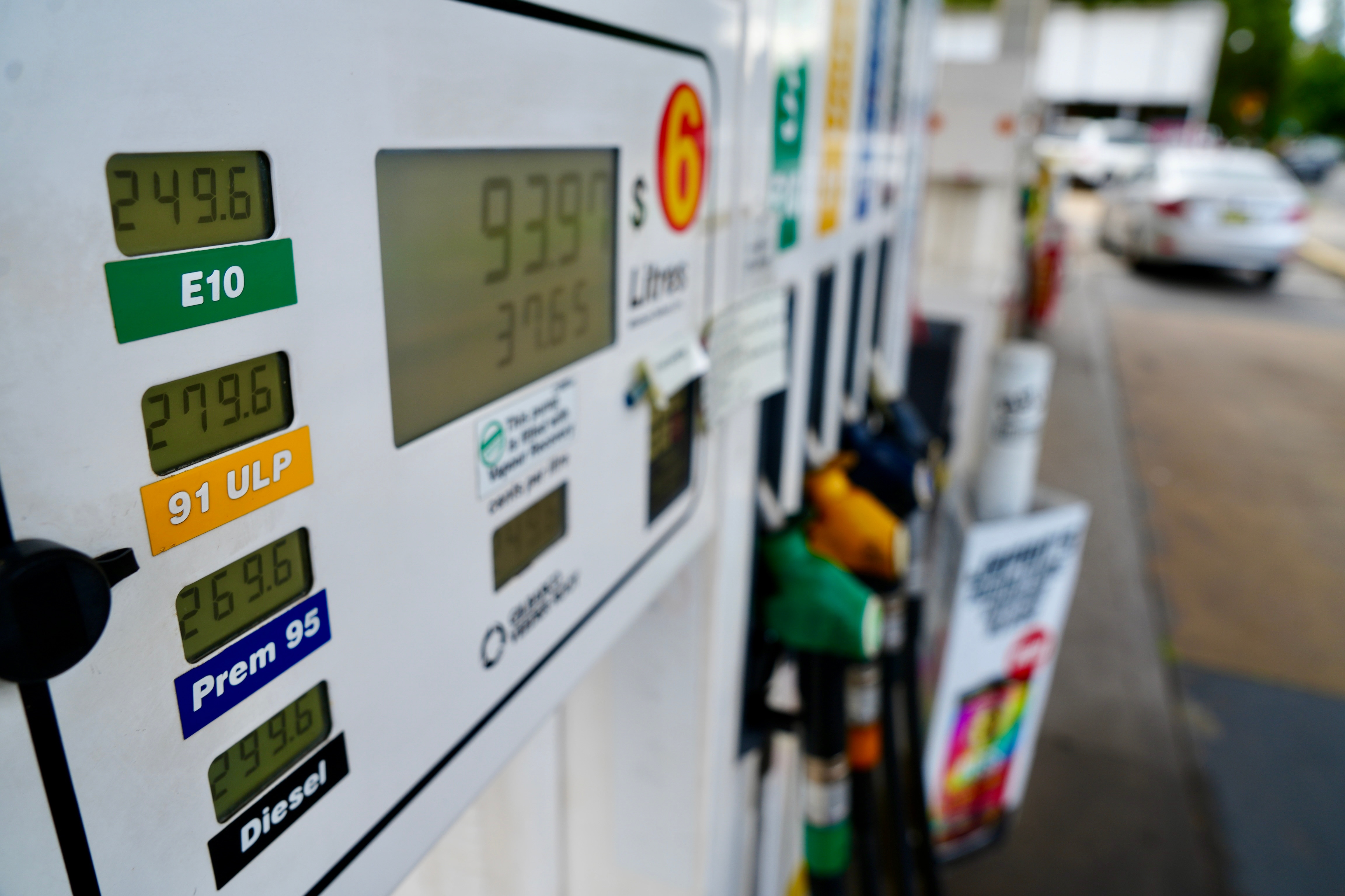 A petrol bowser at a service station, showing pumps and current prices.