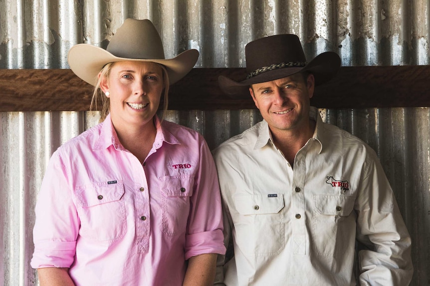 Matt Cherry and Shelley Piper stand together in a farm shed