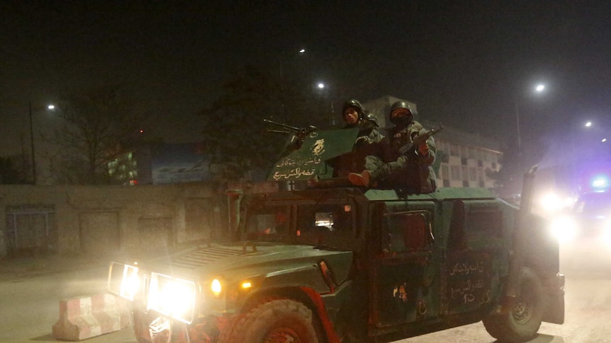 Afghan policemen arrive at the site of a Taliban attack in Kabul