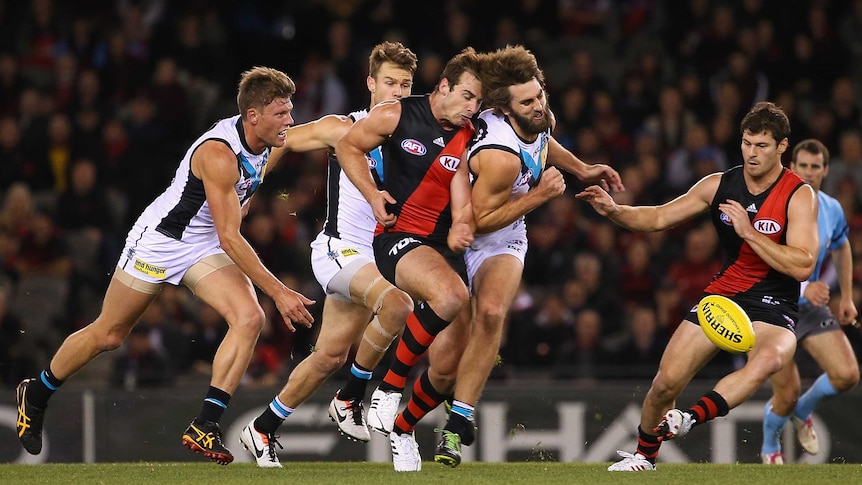 Essendon's Jobe Watson is bumped by the Power's Justin Westhoff at Docklands.