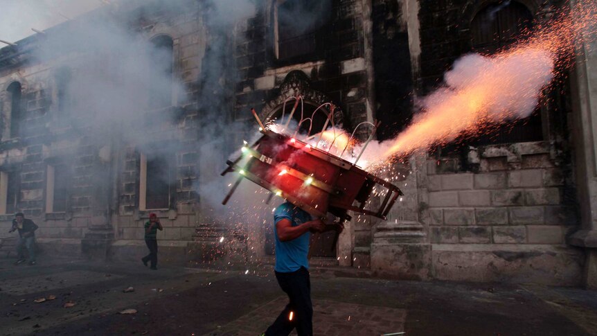 Sparks fly as fireworks explode from a 'toro encuetado' in Nicaragua