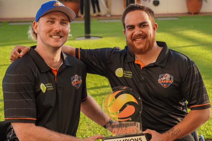  Tom and CJ In 2022 with the National Wheelchair Basketball League championship trophy.