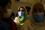 A Christian woman wears a face mask to protect against coronavirus during a prayer service