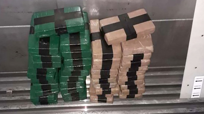 Cocaine bricks seized and stacked in a shipping container