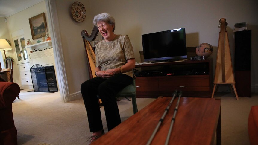 Vanessa Fanning, who has multiple sclerosis, laughs while sitting in her lounge room.