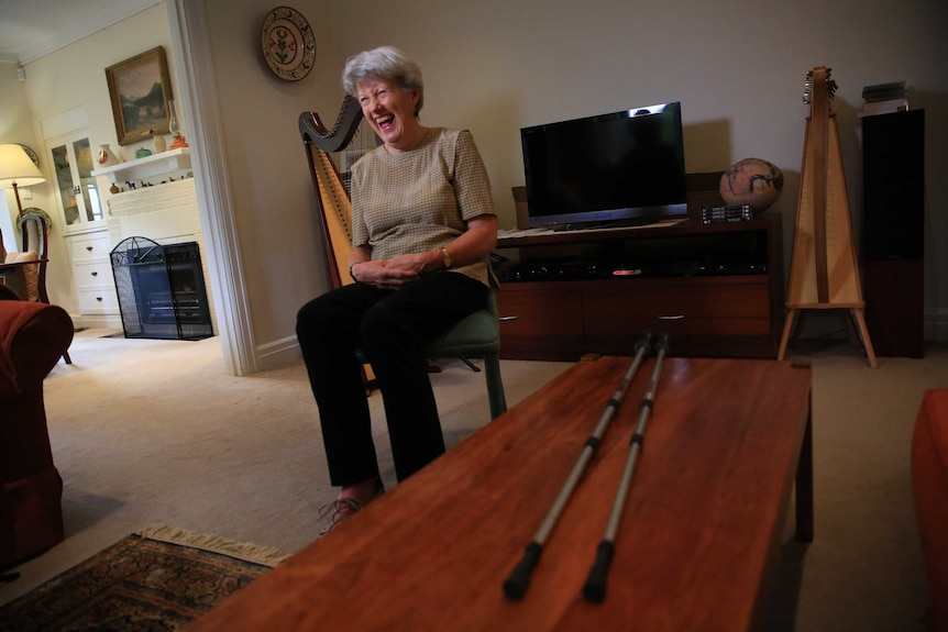 Vanessa Fanning, who has multiple sclerosis, laughs while sitting in her lounge room.