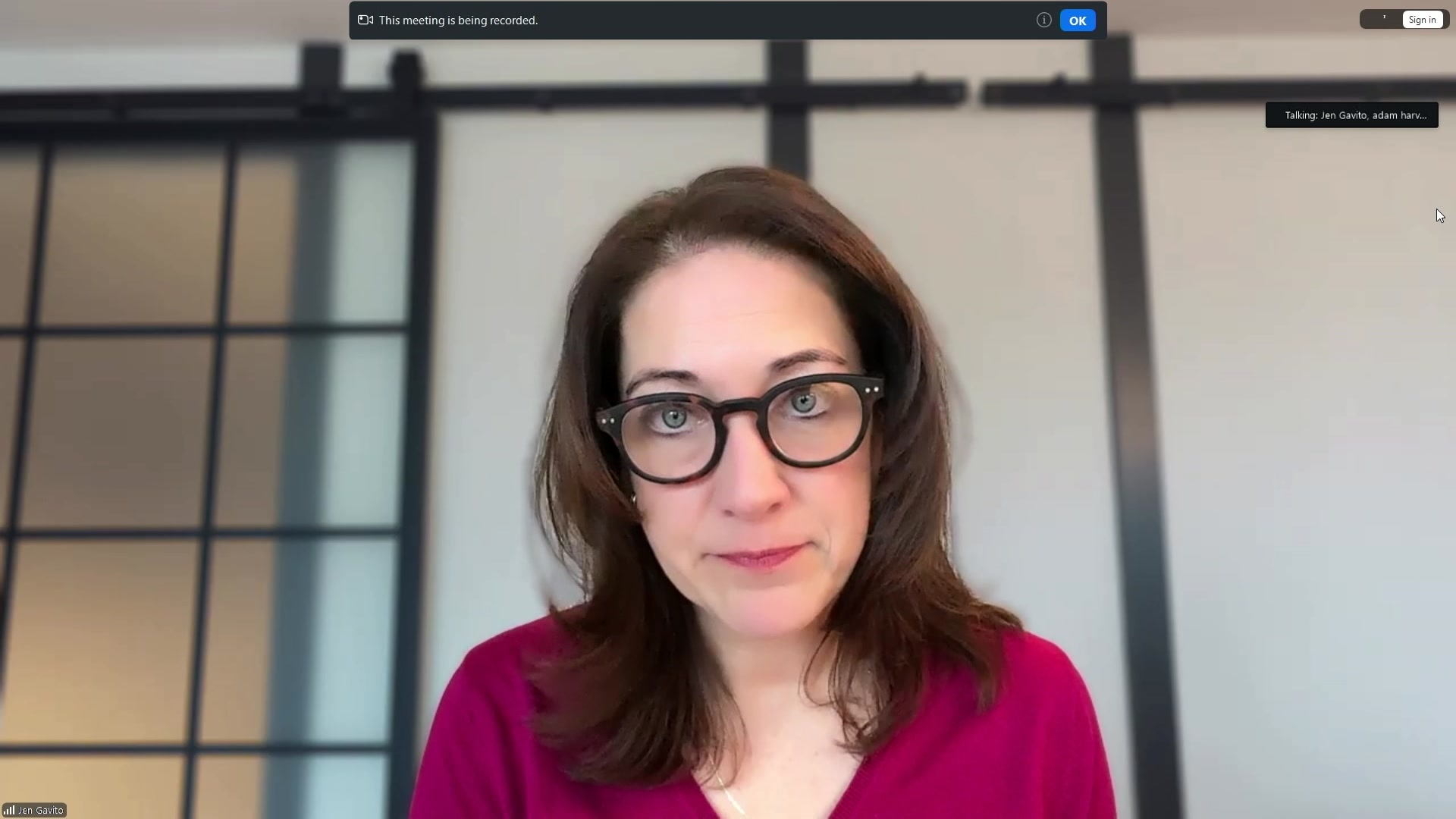 A woman with medium brown hair and dark-framed glasses. 