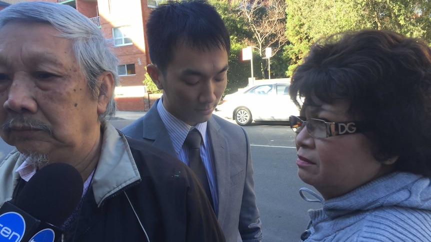Daniel Huynh in front of court with his parents.