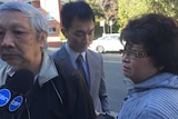 Daniel Huynh in front of court with his parents.