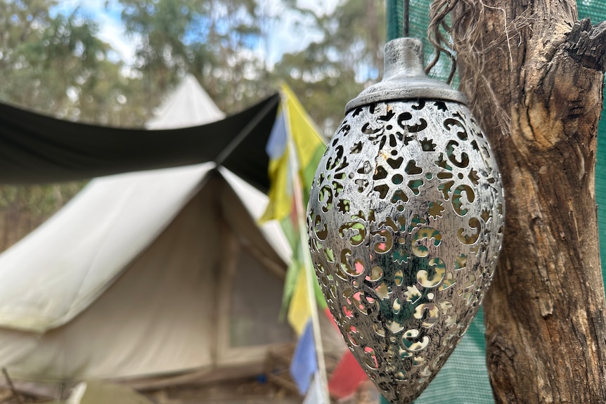 An ornament in a tree outside a tent