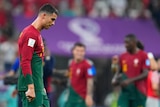 Portugal's Cristiano Ronaldo hangs his head on the field after beating Switzerland 6-1 at the FIFA World Cup in Qatar.