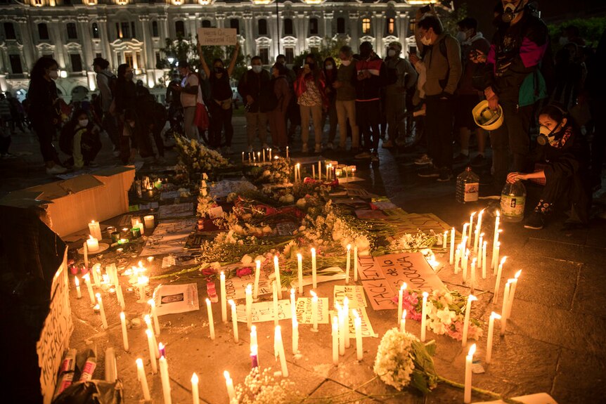 People in Peru gather next to a memorial for the victims of the recent protests, in San Martin Square.