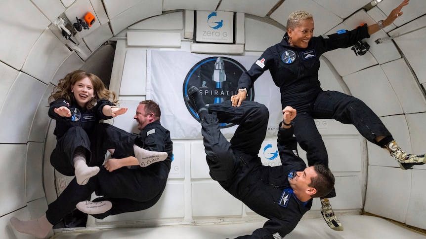 Four people float inside a modified Boeing 727 during a zero gravity flight out of Las Vegas.