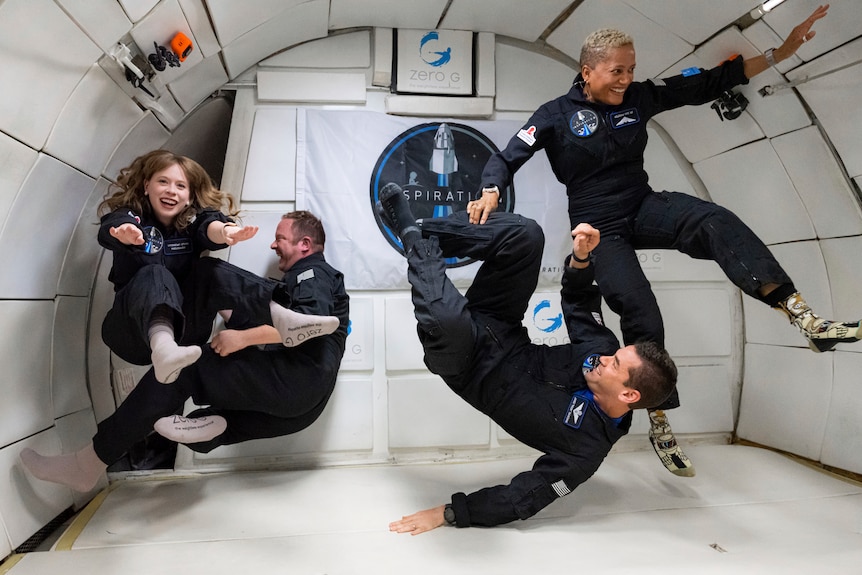 Four people float inside a modified Boeing 727 during a zero gravity flight out of Las Vegas.