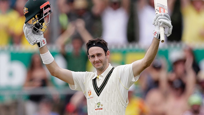 Kurtis Patterson raises his bat and helmet in celebration after scoring his maiden Test century