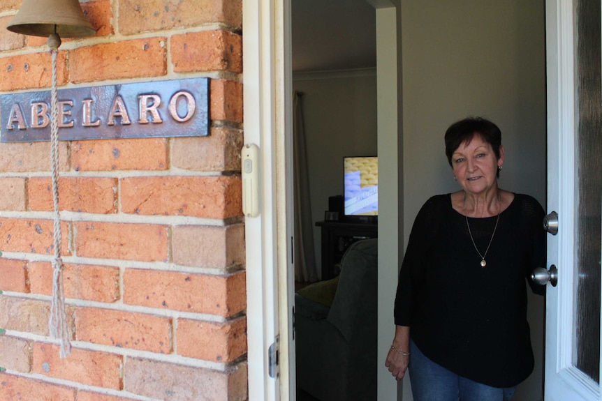 Joanne Mara standing at an open door.