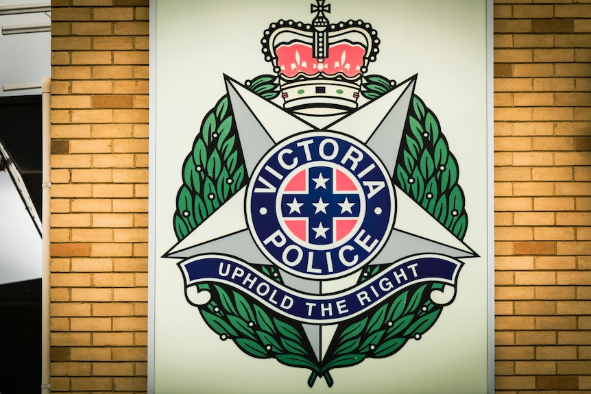 A large sign of the Victoria Police badge, bearing the inscription "uphold the right".