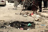 The hole left in the road by the car bomb outside the Al-Muayad mosque.