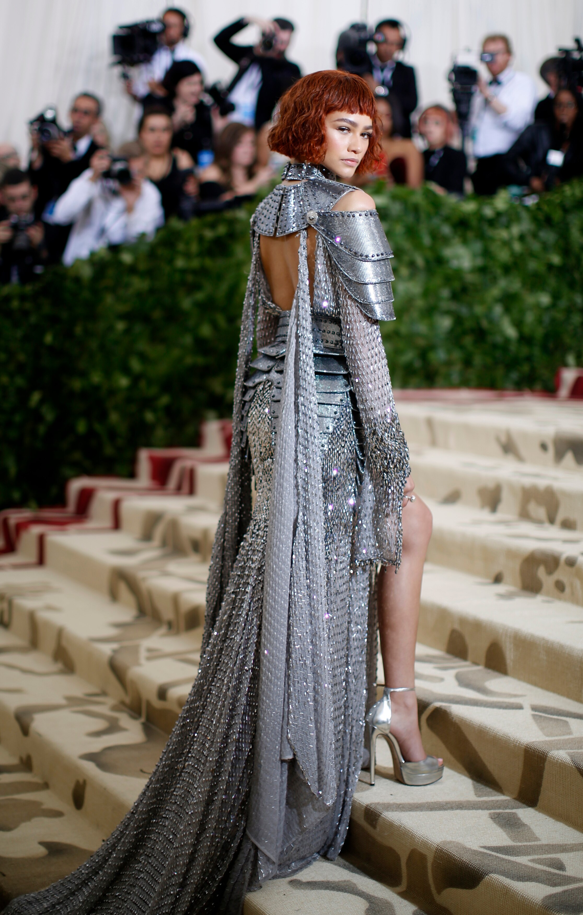 Zendaya wearing a silver metallic dress with chain-mail-like fabric and armour-like shoulder detailing