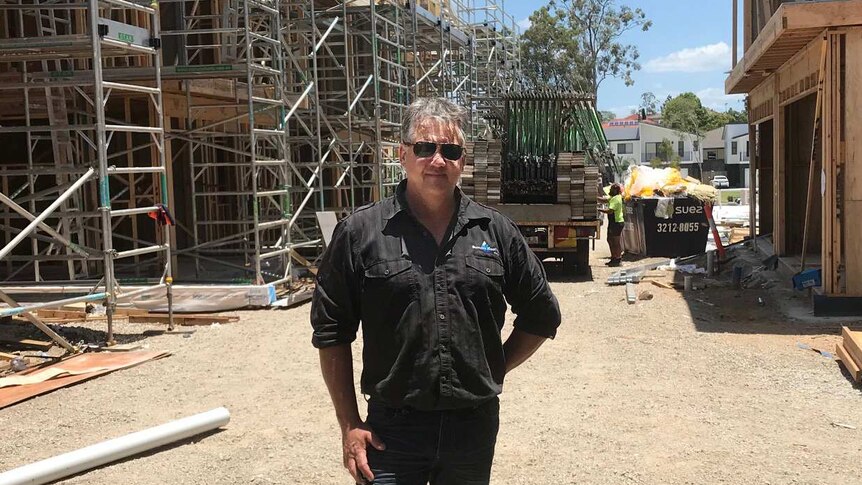 Hayden Quaife stands on a construction site