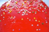 Red jelly with coloured confectionary on top.