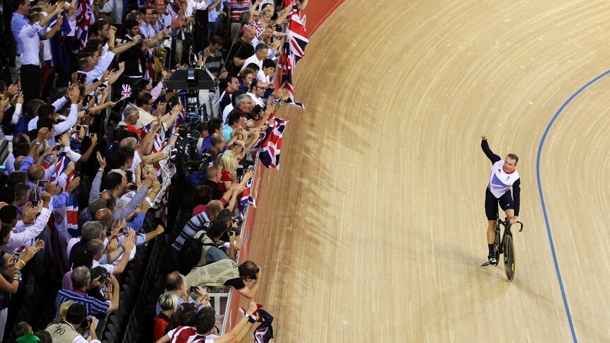 Britain's Chris Hoy waves at the crowd after he and his team-mates won gold in the track cycling.
