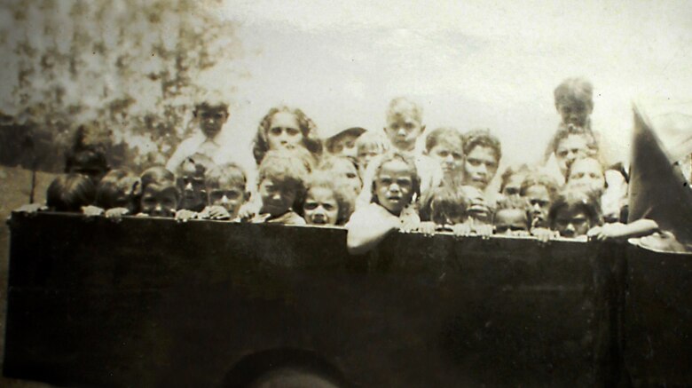 26 Aboriginal students in the back of a 1930s pick up truck the teacher used to take them to school.