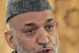 Afghan President Hamid Karzai gestures as he speaks during a news conference