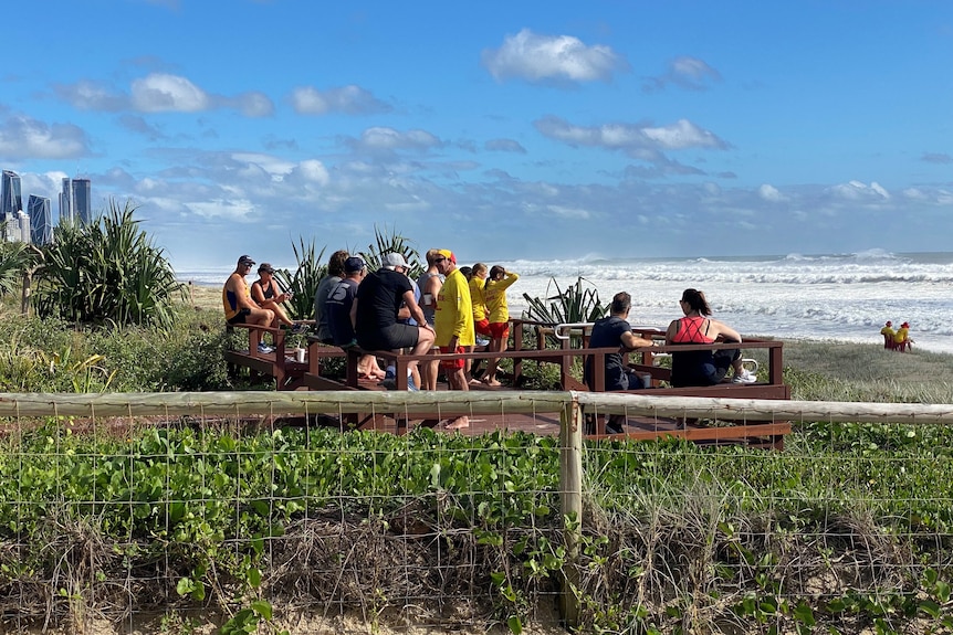 A crowd watches wild surf on Mermaid Beach on the Gold Coast
