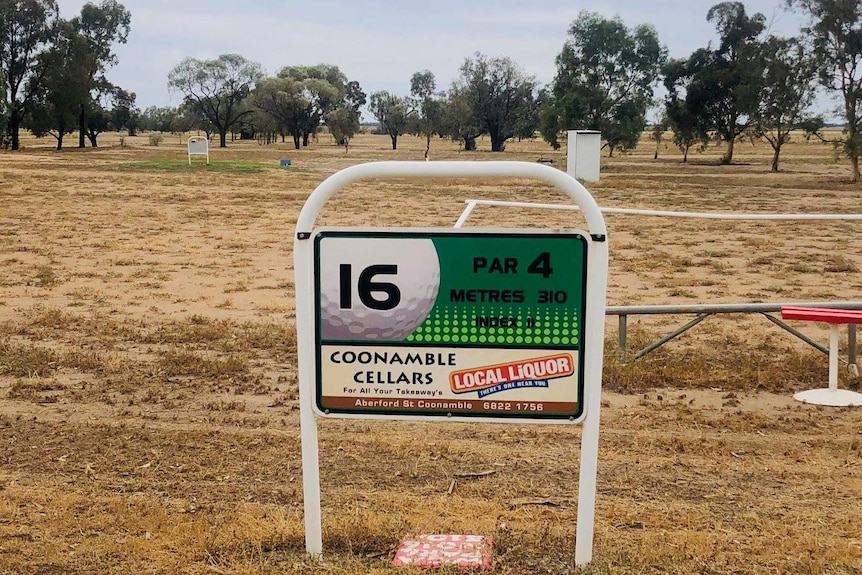 A sign on a golf course for hole 16