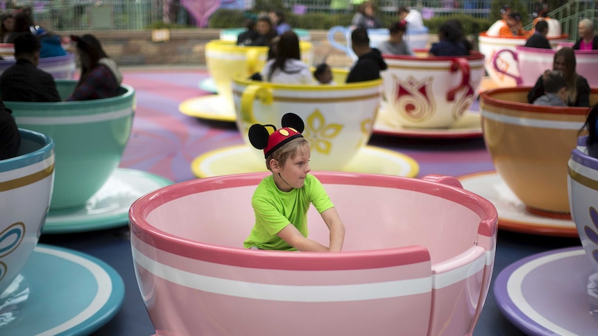 A boy rides the Mad Tea Party at Disneyland in California