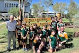 Primary school kids in front of the Muttaburra state school sign