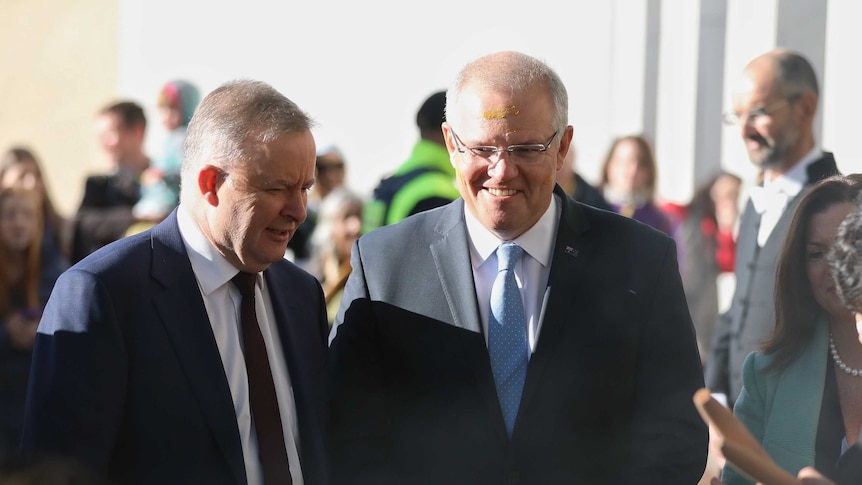 Anthony Albanese and Scott Morrison talk to each other outside Parliament House