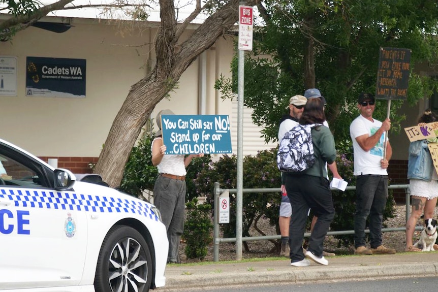 Protesters in front of a school